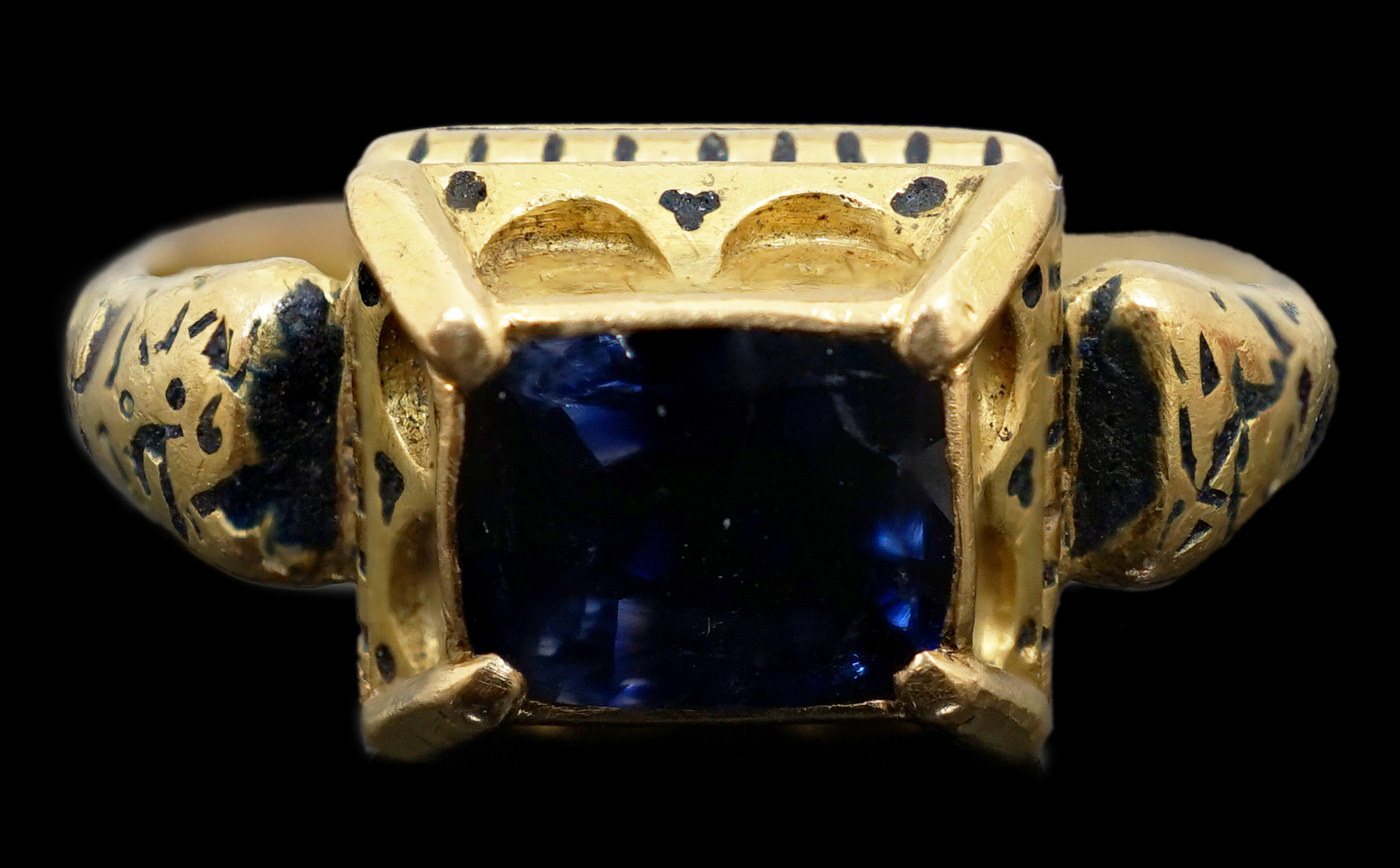 An antique high carat gold, black enamel and collet set cushion cut sapphire set 'poison' ring